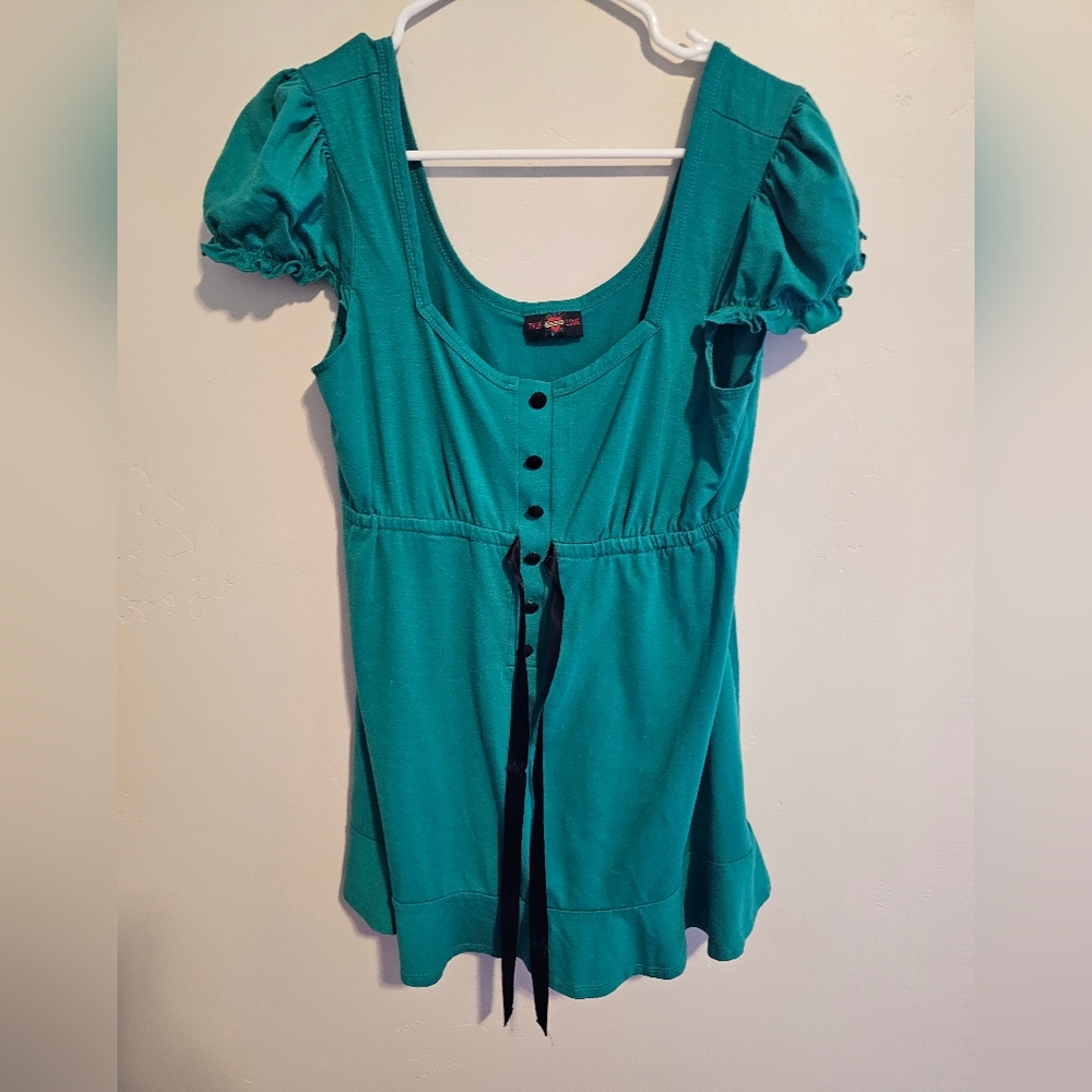 Green shirt with black tie.